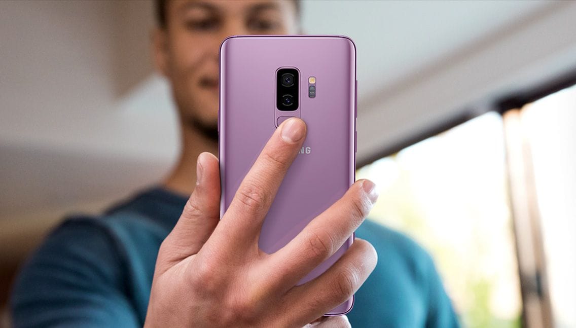 Photo of person holding Galaxy S9+ to show fingerprint scanner placement