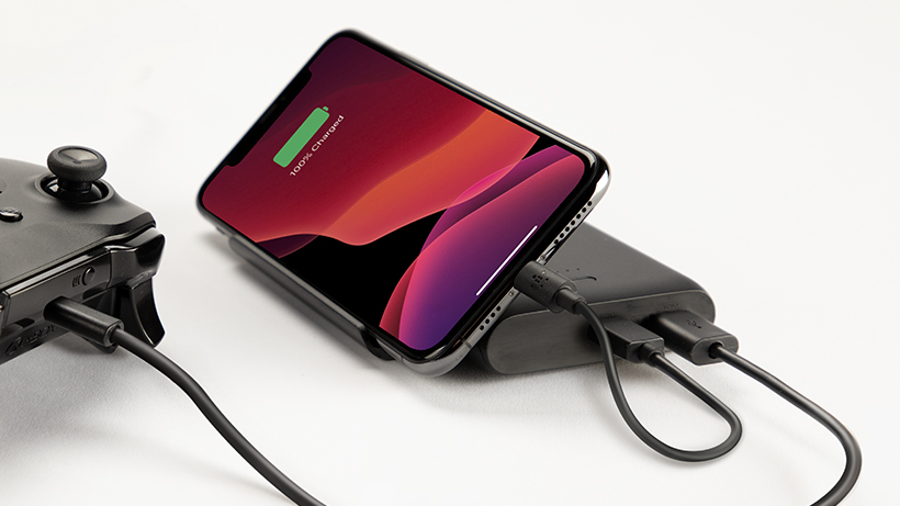 BOOSTCHARGE Power Bank charging a smartphone and controller simultaneously