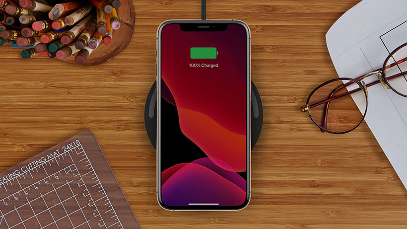 BOOSTCHARGE Wireless Charging Pad charging a smartphone on a desk